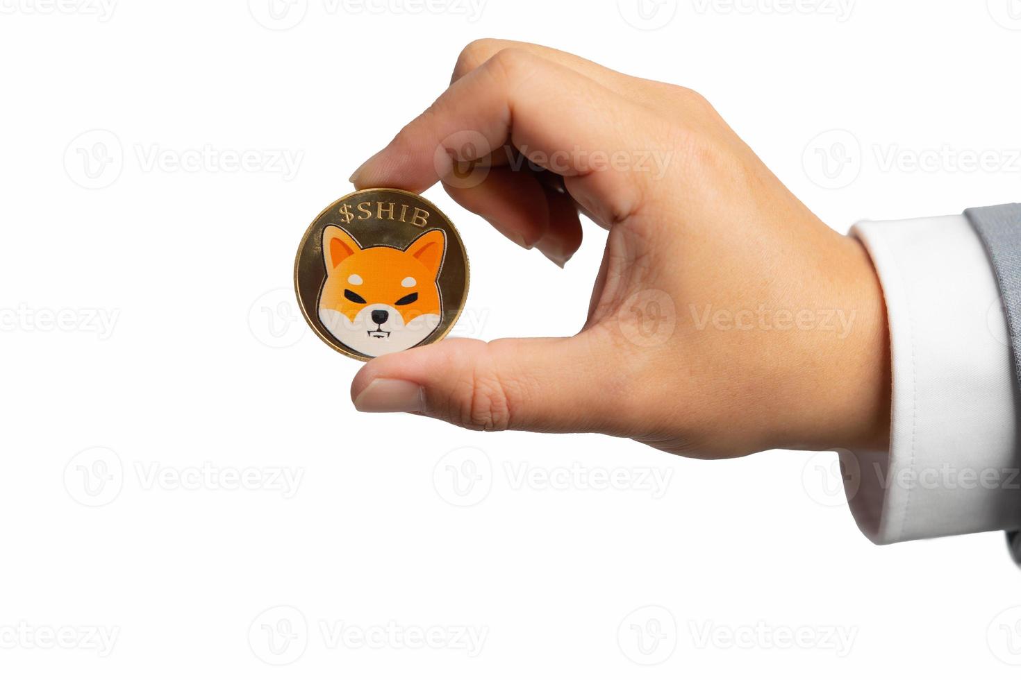 Hand or fingers picking Shiba coin group included with Crypto currency on hand business man in gray suit. Filed and put and give to me isolated on white background. photo