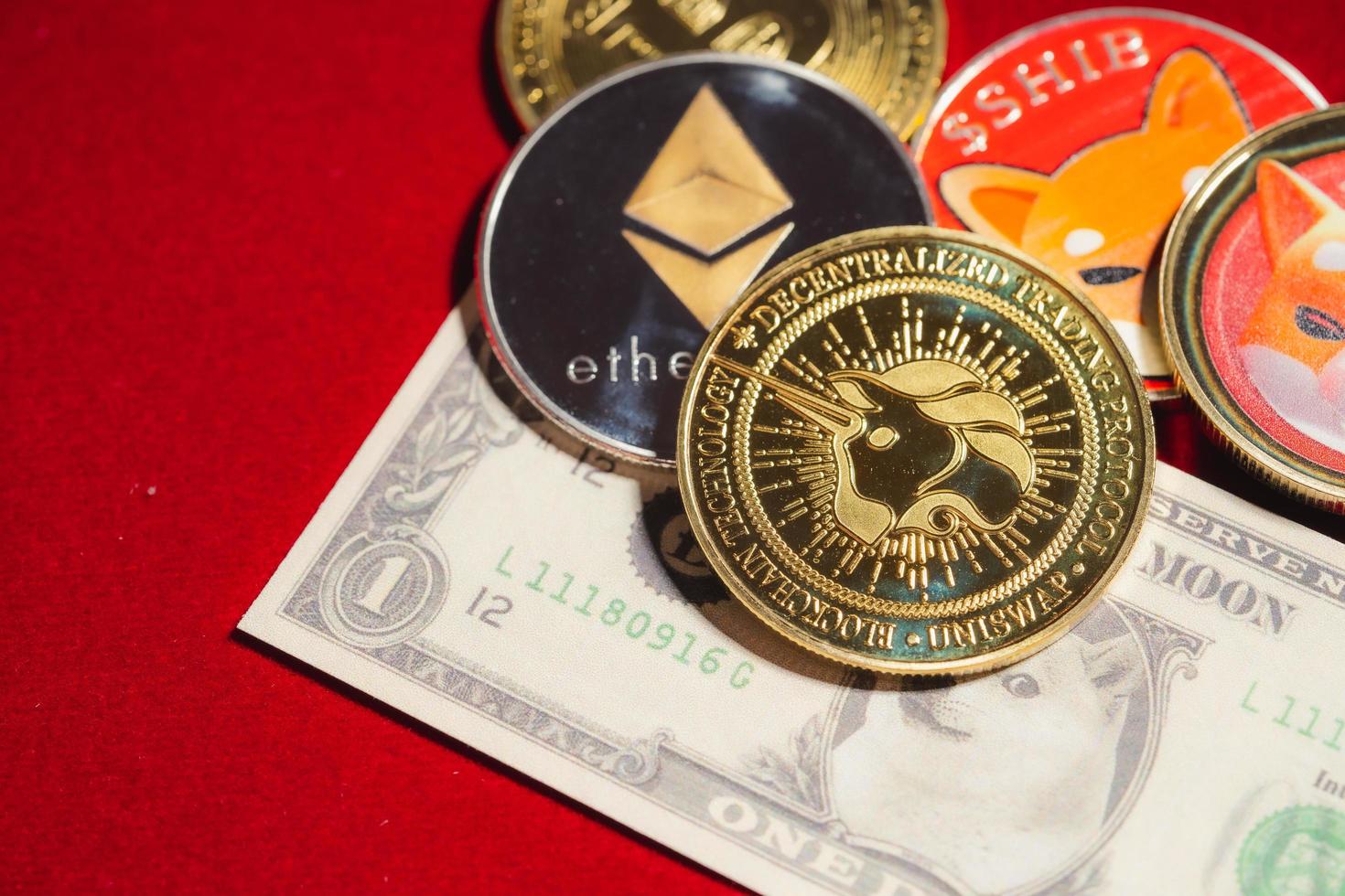 Uniswap UNI, bitcoin, Ethereum ETH, Shiba Coin, included with Crypto currency coin  on stack 100 hundred new US dollar Money American Virtual blockchain technology future is money Close up concept photo