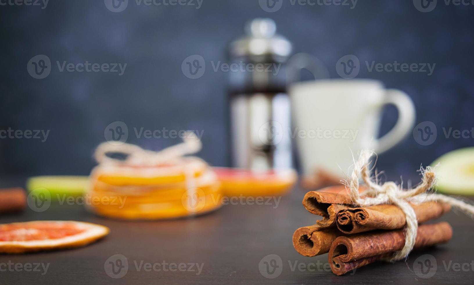 Fruit tea with apple, grapefruit and cinnamon on wooden background photo