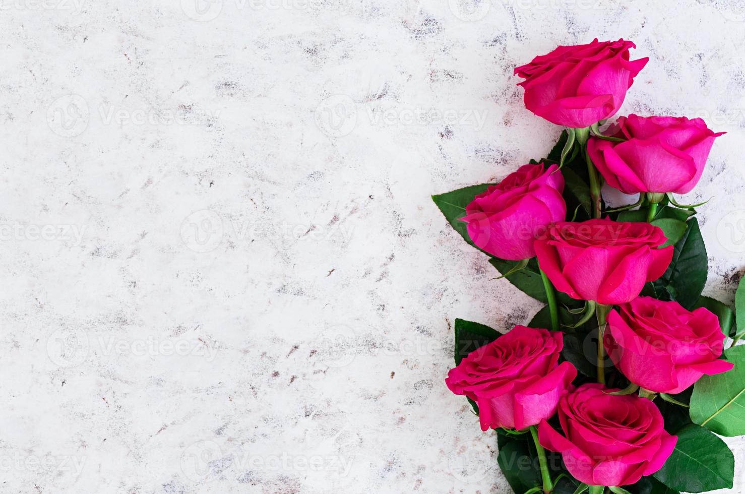 Bouquet of pink roses on dark background. Top view photo