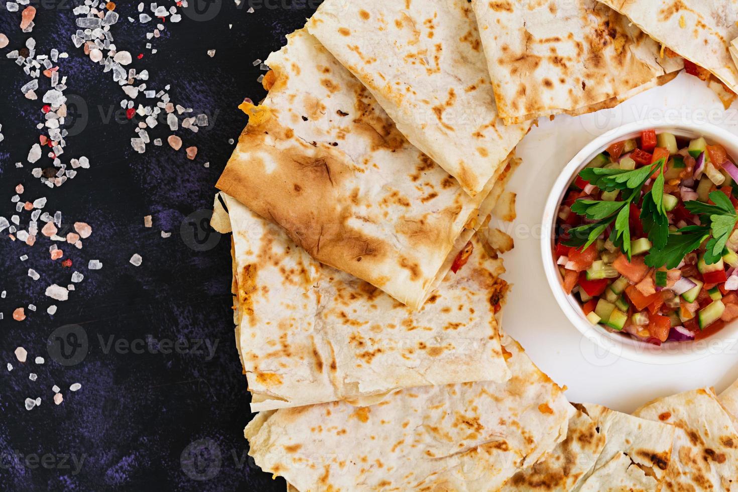 Quesadilla with chicken and corn on dark background. Top view photo