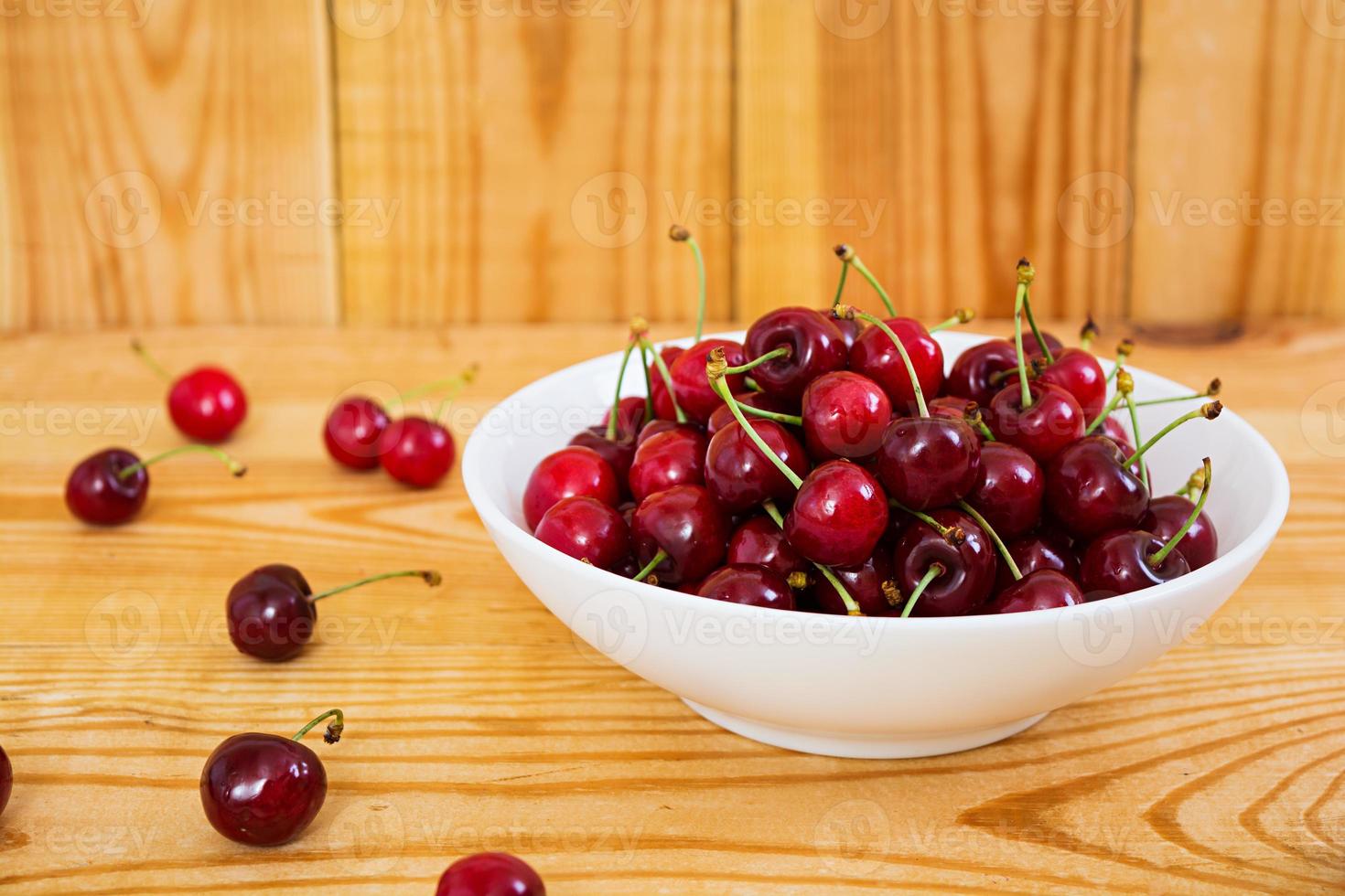 Tasty sweet cherry on wooden background photo