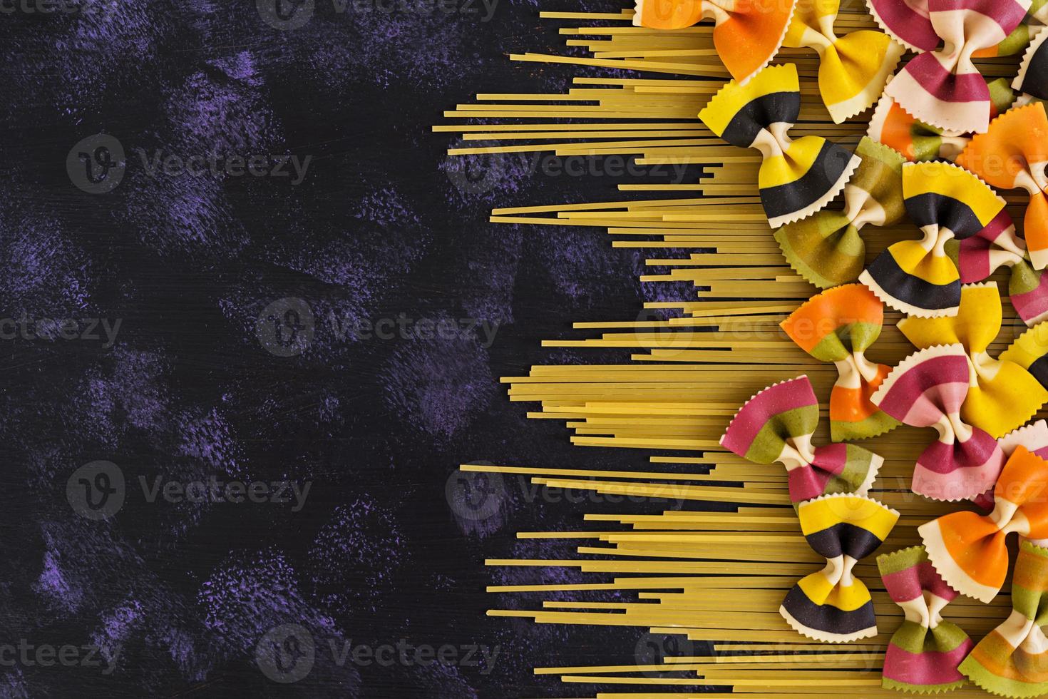 Mixed colorful farfalle pasta. Flat lay. Top view. photo