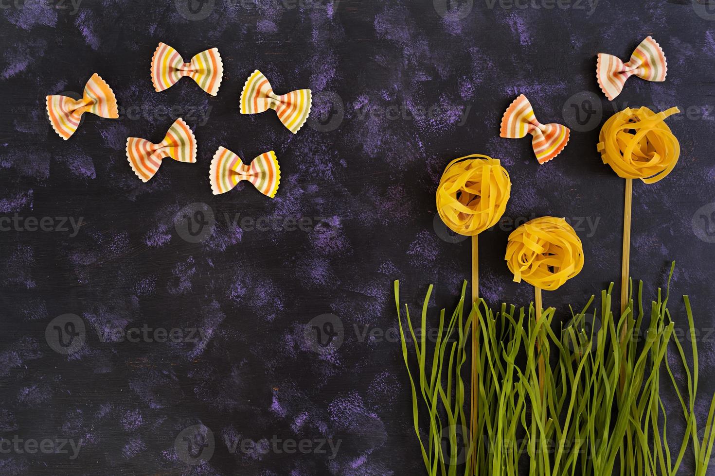 Dry pasta background. Different pasta on dark background. Flat lay. Top view. photo