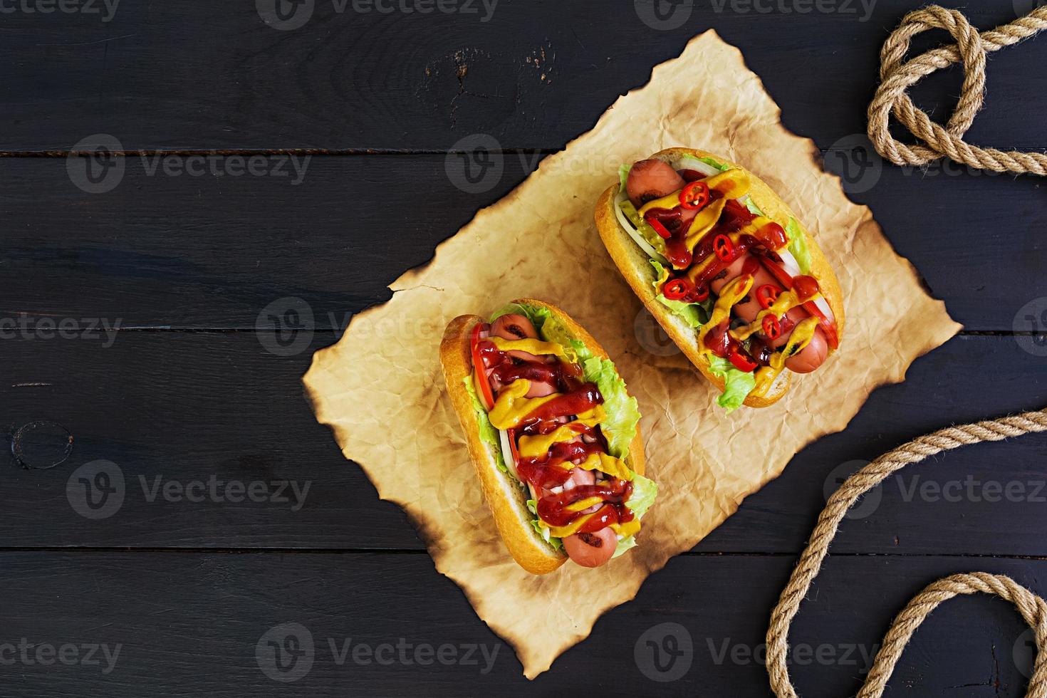 Delicious homemade hot dog on dark background photo