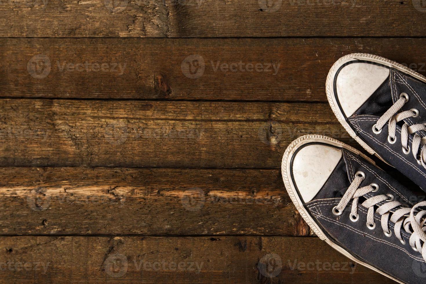 Gumshoes on wooden background photo