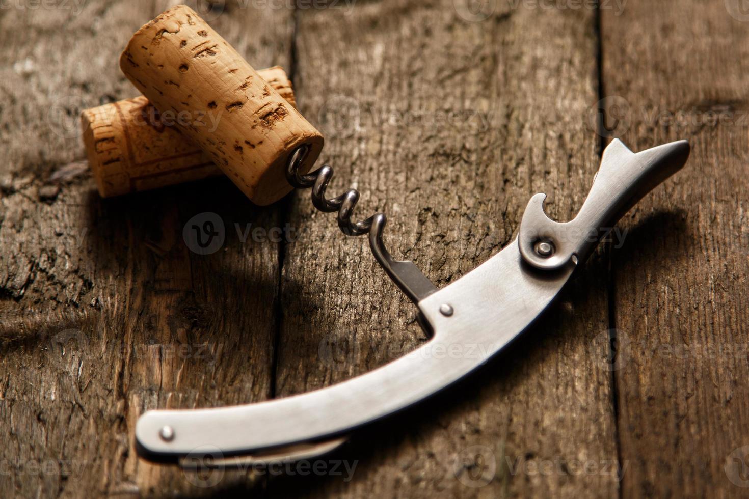 Corkscrew and wine corks photo