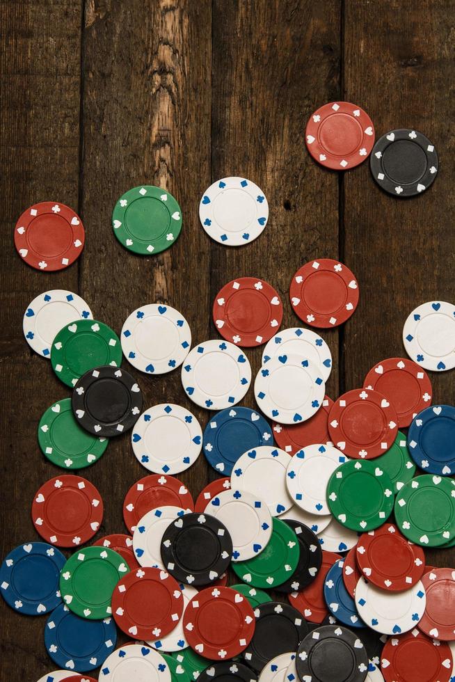 Poker chips on wooden background photo