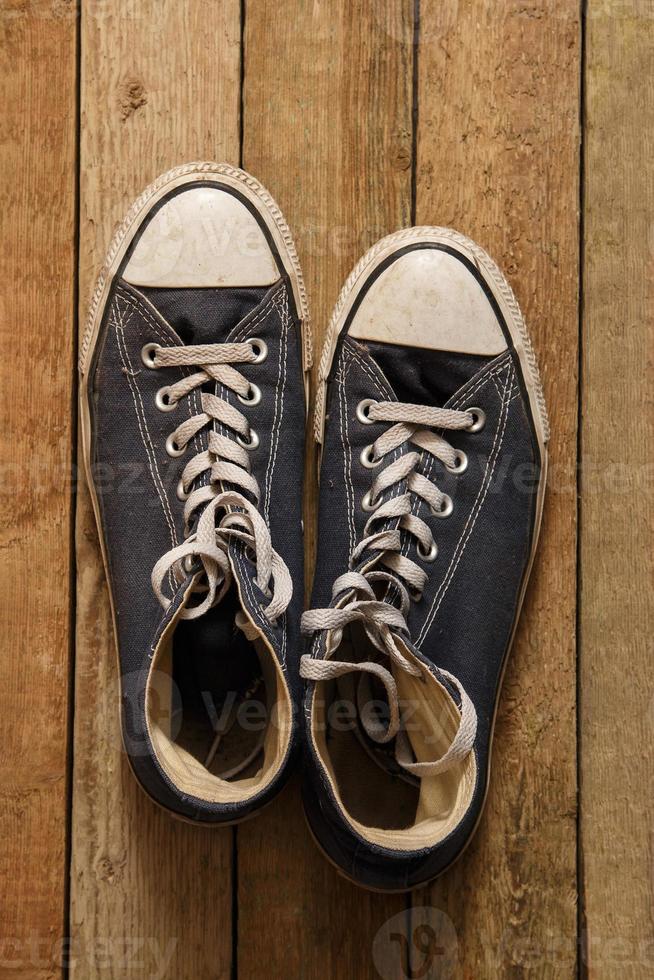 Gumshoes on wooden background photo