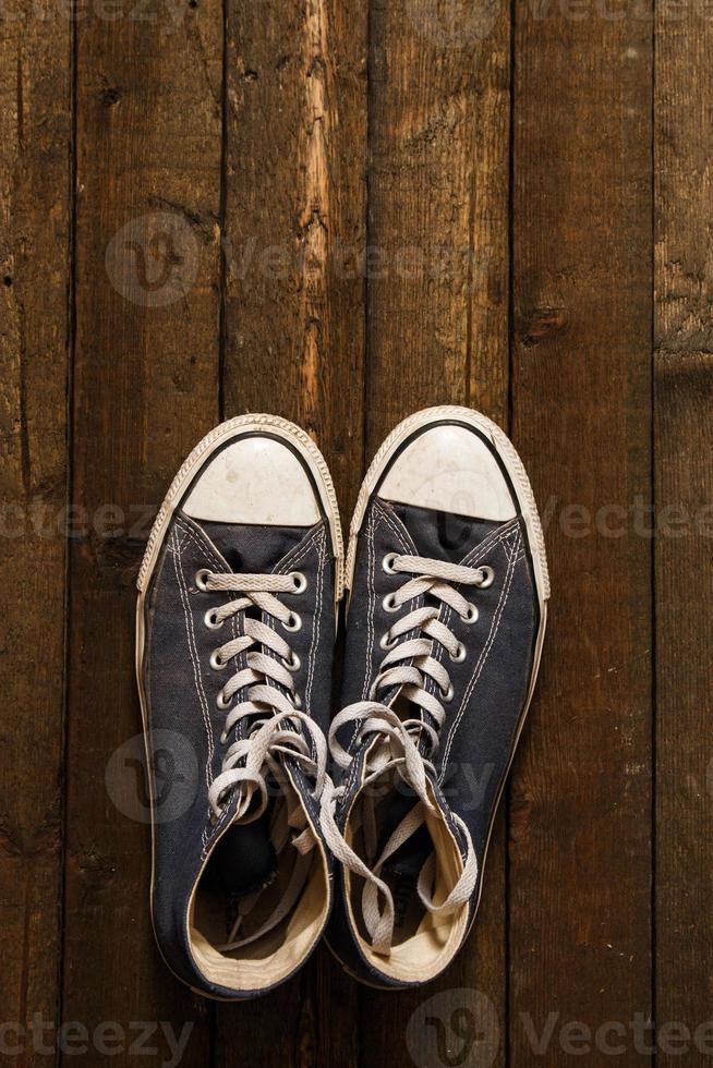 Gumshoes on wooden background photo