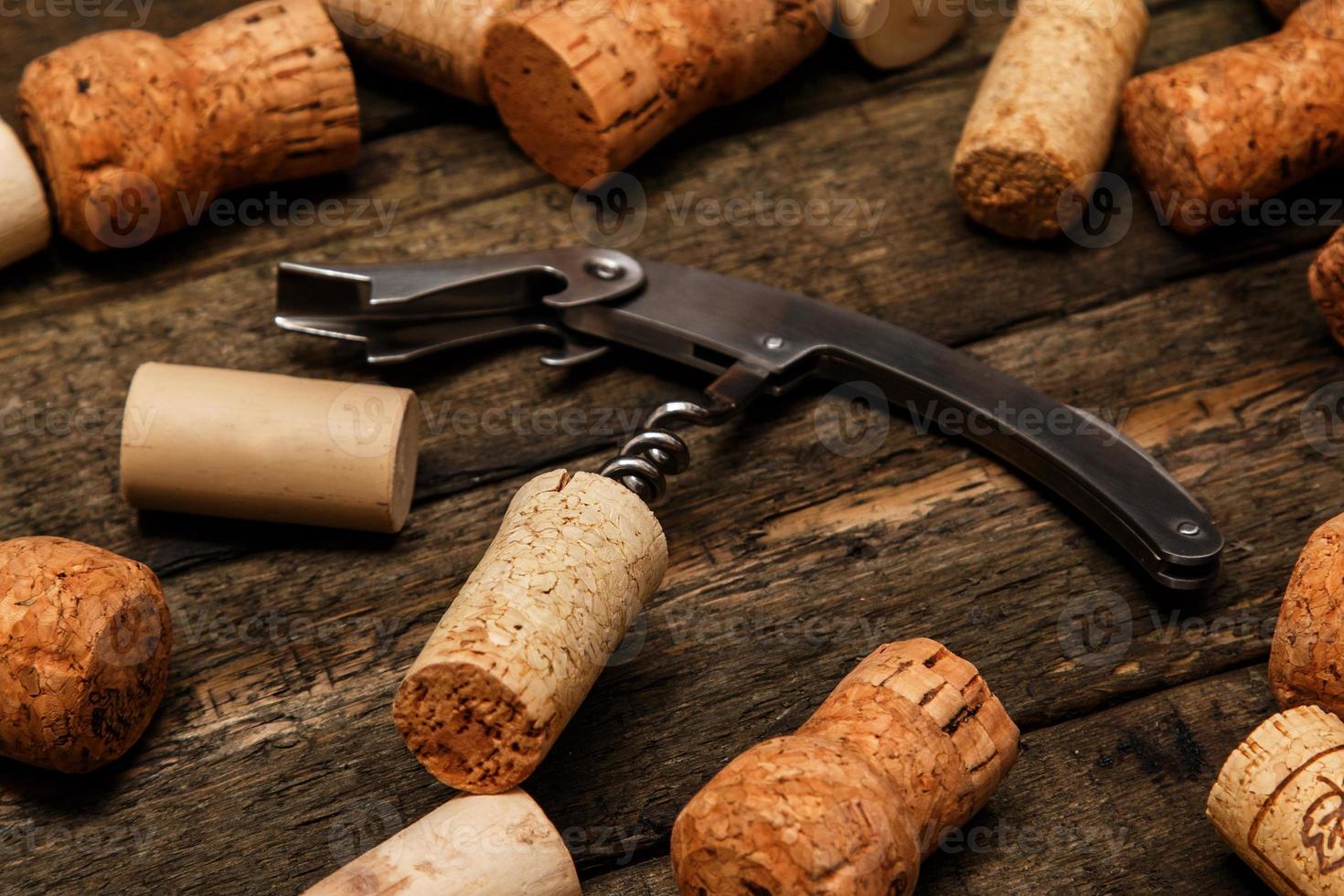 Corkscrew and wine corks photo