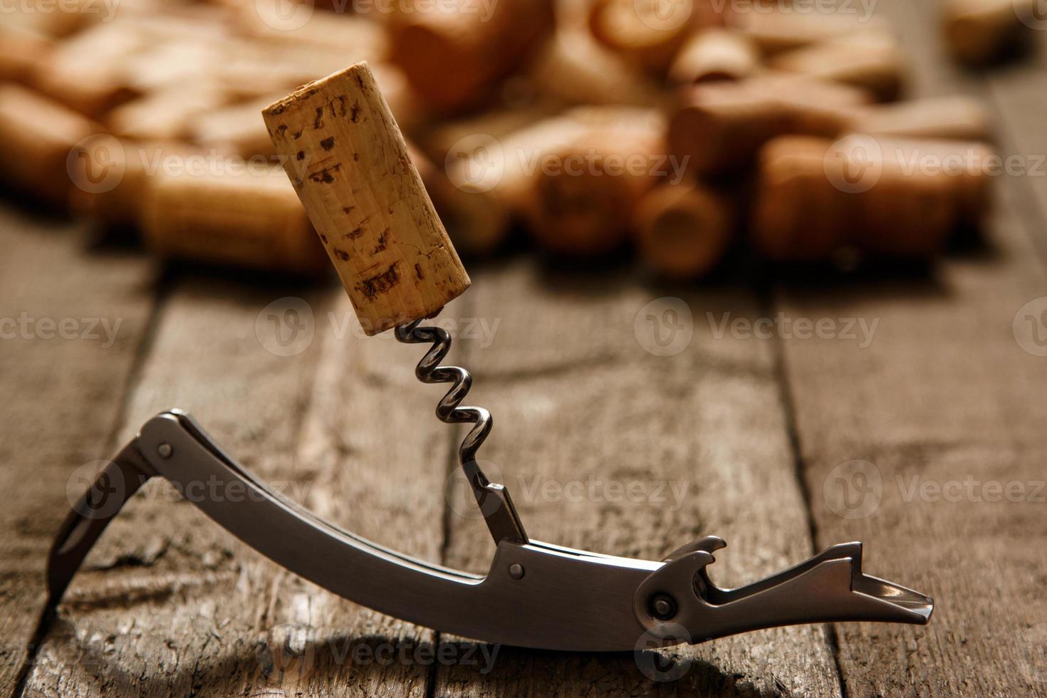 Corkscrew and wine corks photo