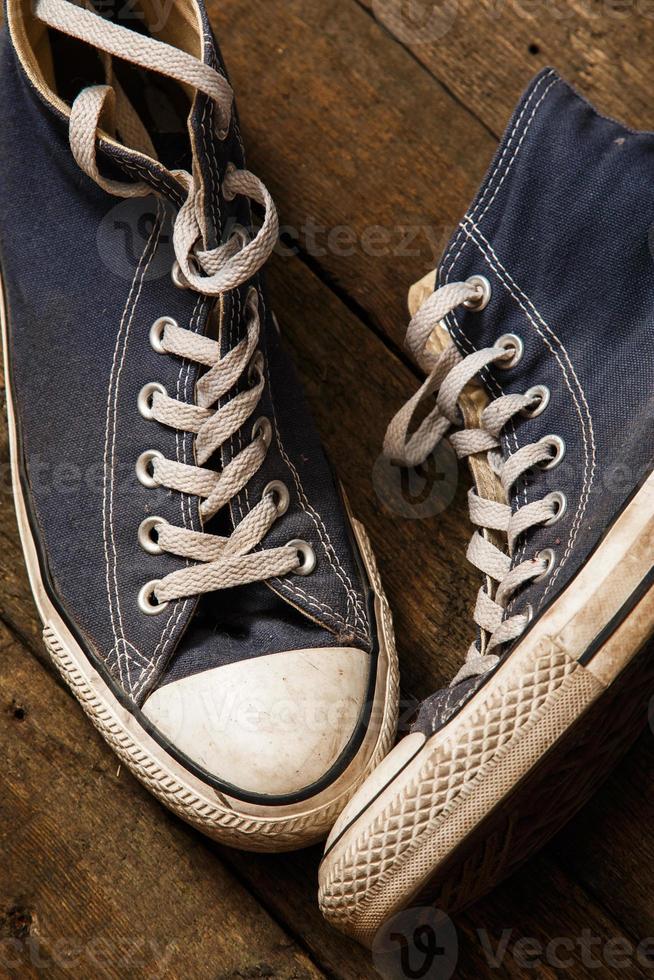 Gumshoes on wooden background photo