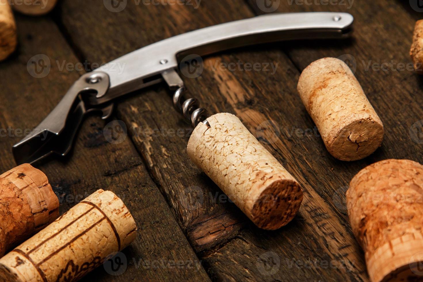 Corkscrew and wine corks photo