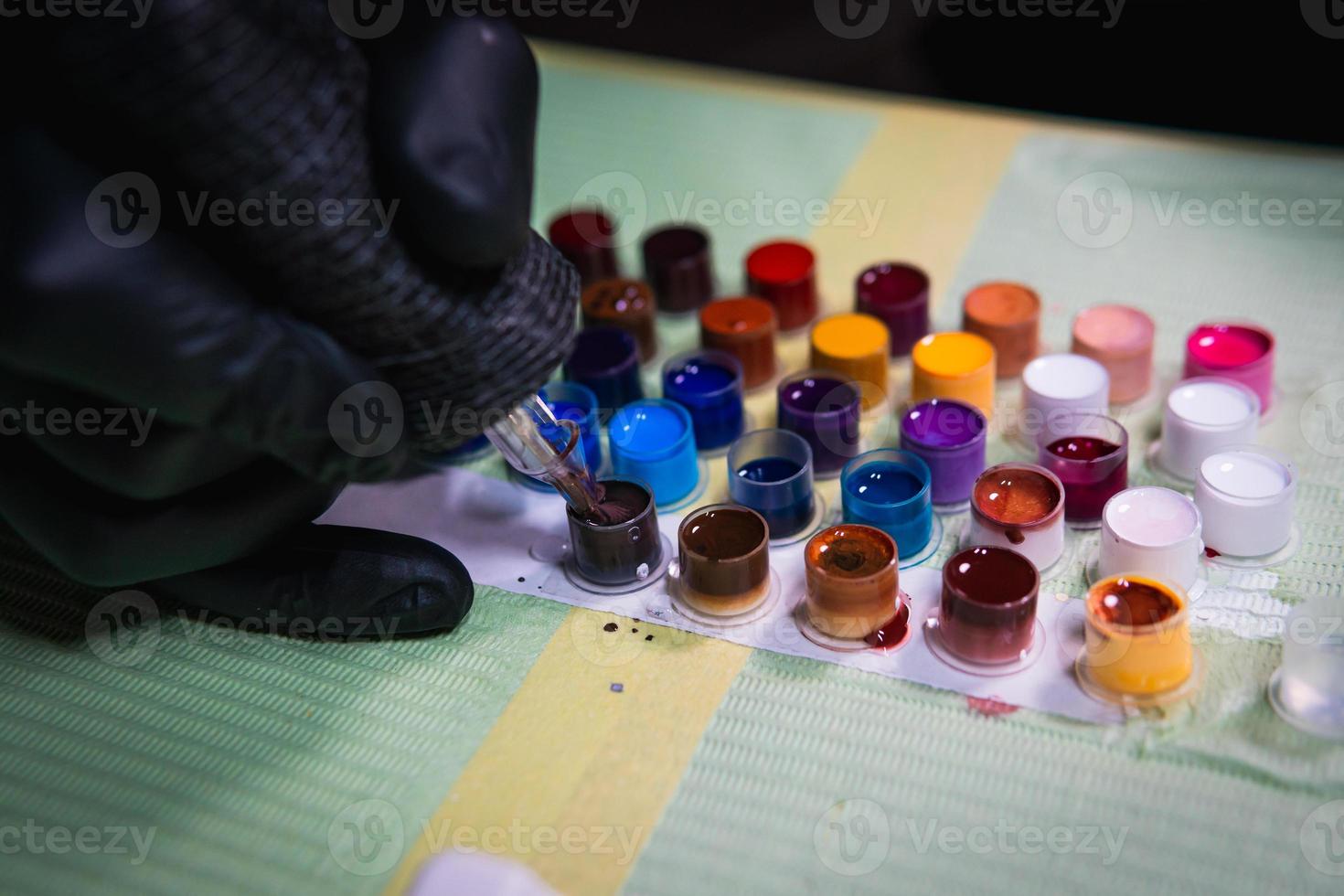 Close-up of tattoo artist work place parts and paint, machines and other equipment. Professional tattooist working photo