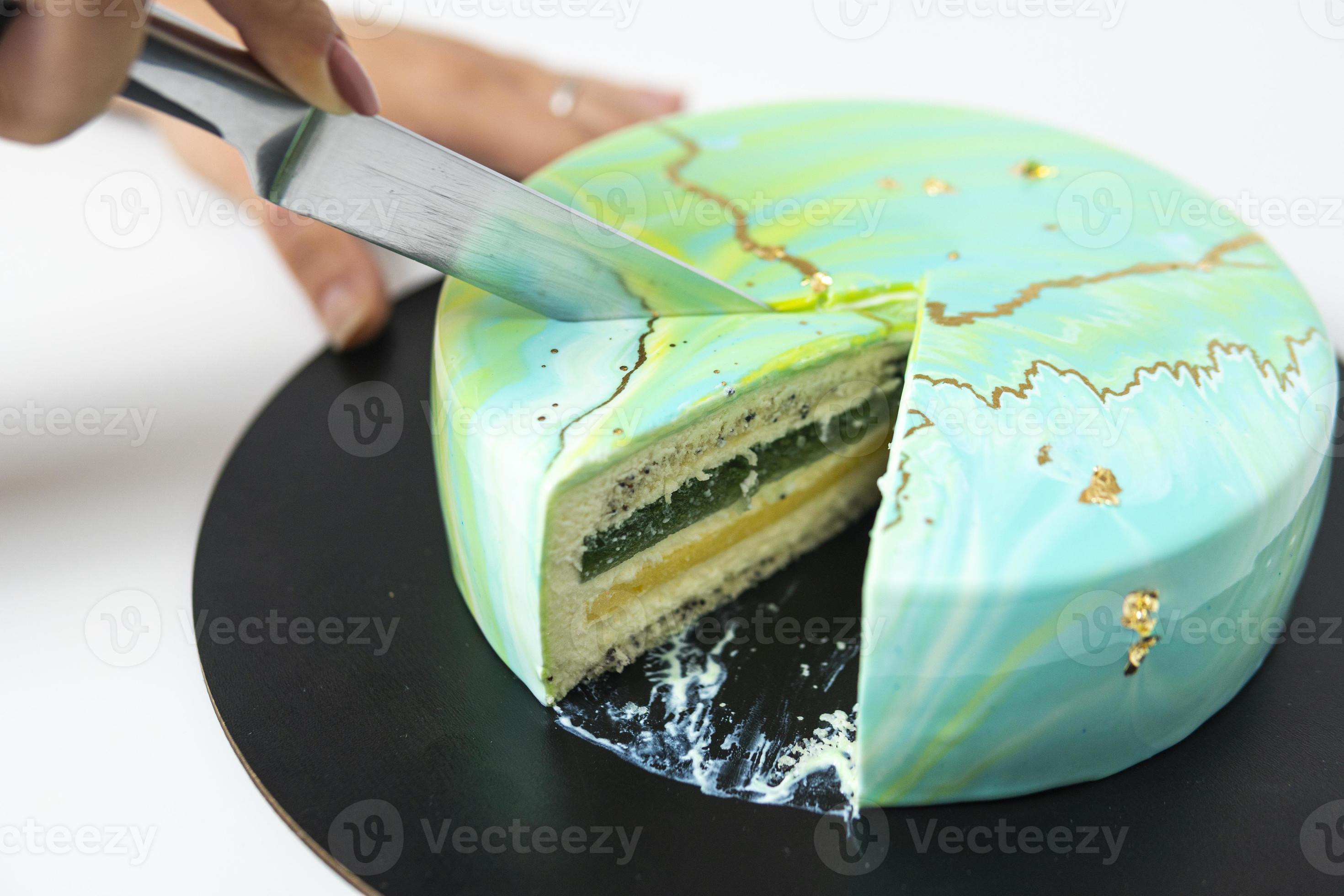 Modern French mousse cake with green mirror glaze. Picture for a menu or a  confectionery catalog. Stock Photo | Adobe Stock