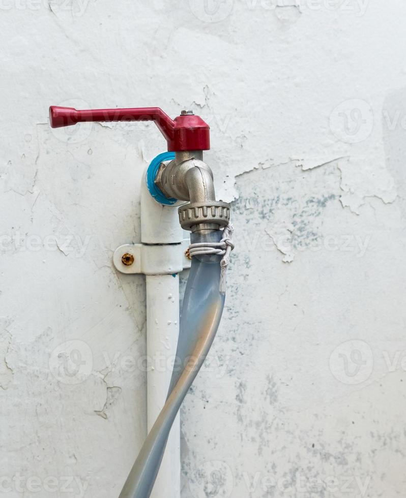 Metal faucet with old tube. photo