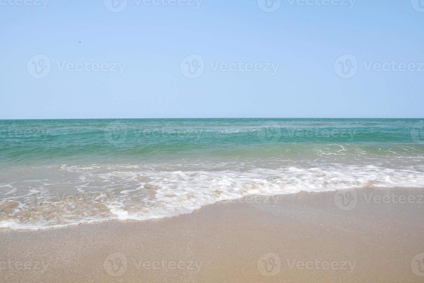 Wide angle shot of sea water hitting the beach, white sponge of the sea, summer nature background image concept. photo