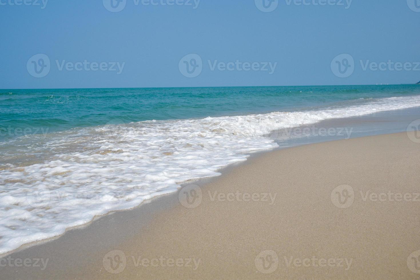 Wide angle shot of sea water hitting the beach, white sponge of the sea, summer nature background image concept. photo