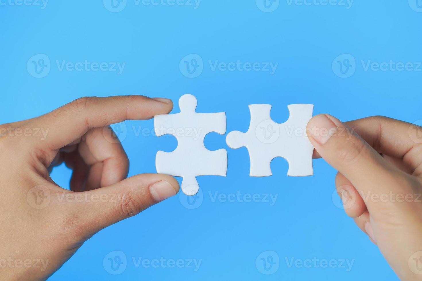 Businessman hand connecting jigsaw puzzle, Business solutions, target, success, goals and strategy concepts photo