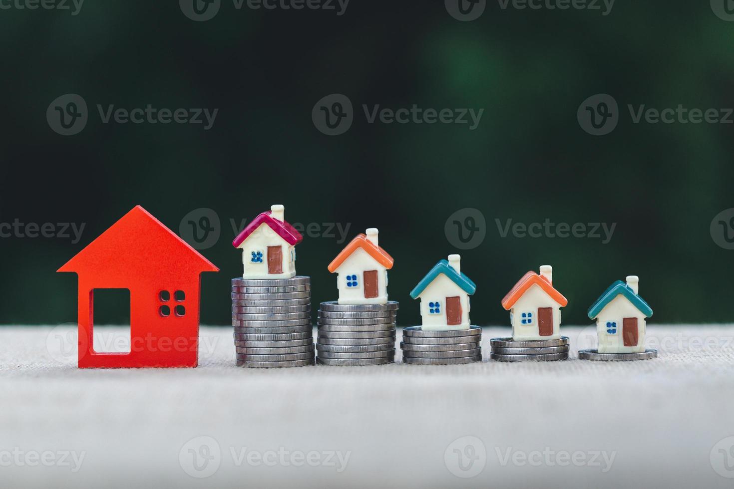 coin stack with house model, savings plans for housing ,financial concept,Concept of real estate investment. photo