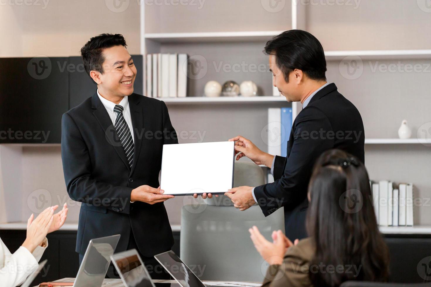 Employee gets a certificate of achievement, Businesspeople with certificate in the office, Businessman giving appreciation certificate to employee for achievement photo