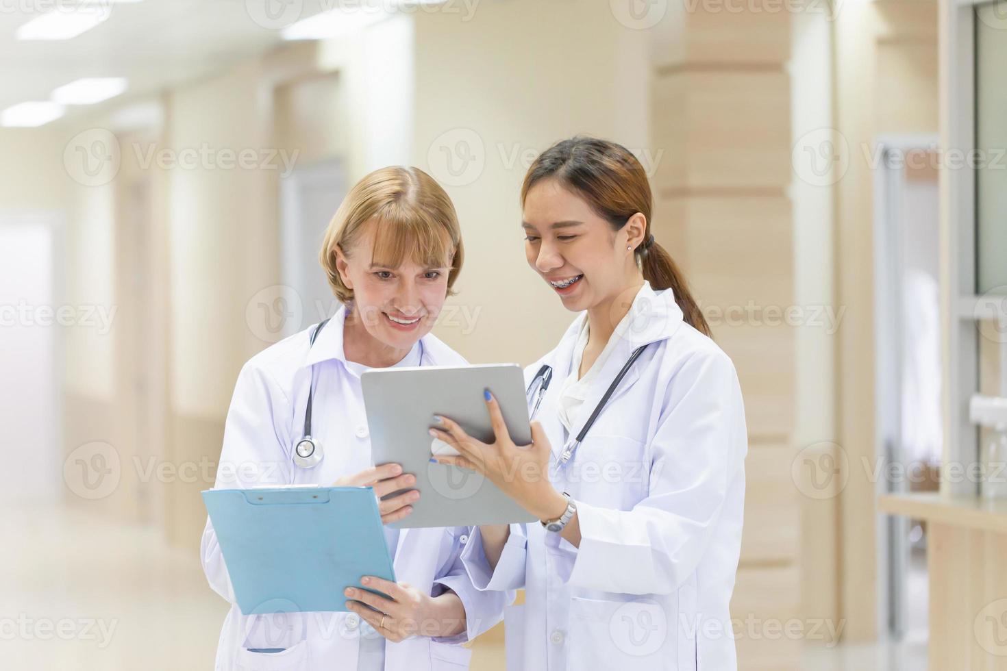 Medical team discussing over digital tablet at the hospital. Medicine and health care concepts photo