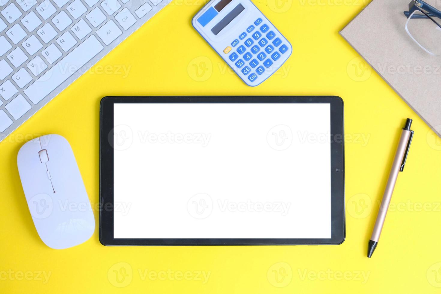 Blank tablet screen while typing on a keyboard, as well as a screen mockup for further customization, can be used for a variety of purposes. area for copying photo