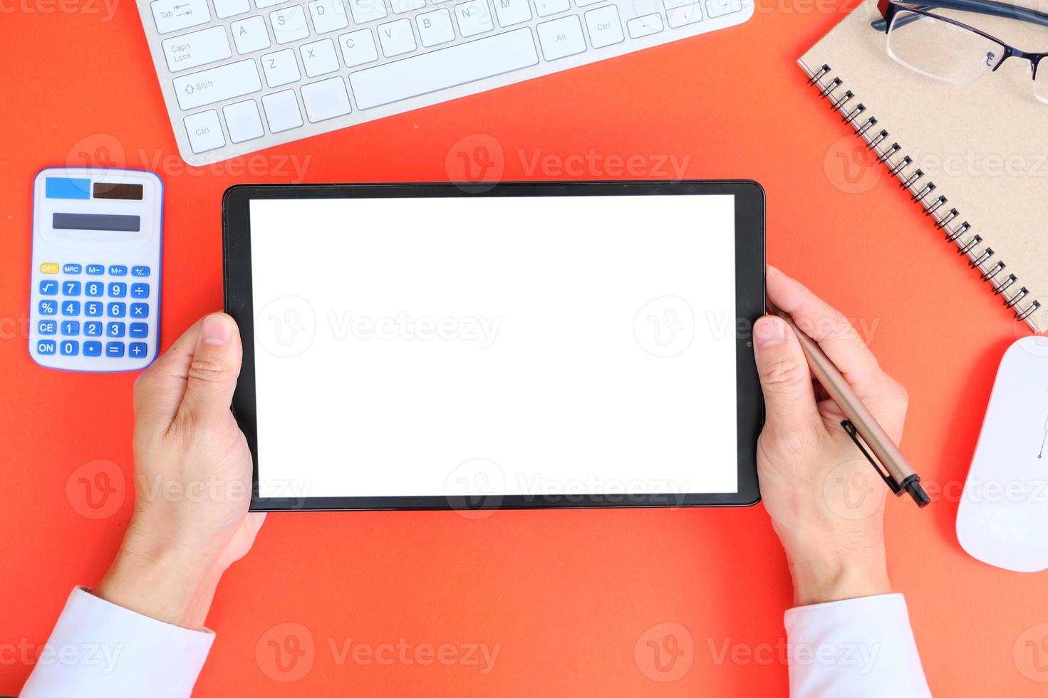 Blank tablet screen while typing on a keyboard, as well as a screen mockup for further customization, can be used for a variety of purposes. area for copying photo