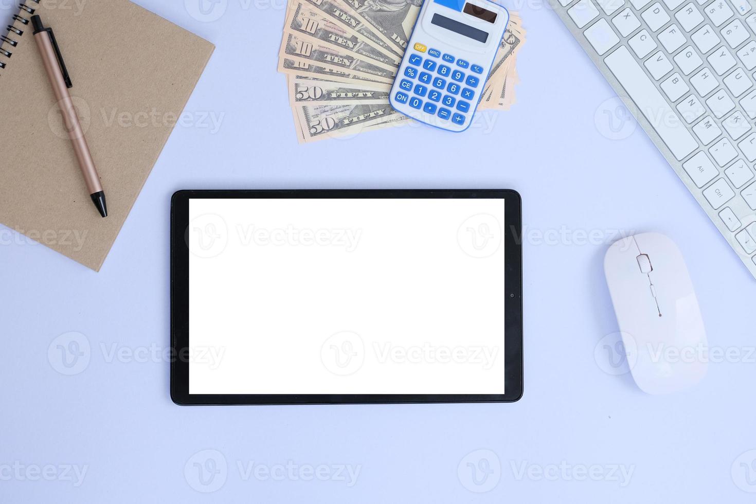 Blank tablet screen while typing on a keyboard, as well as a screen mockup for further customization, can be used for a variety of purposes. area for copying photo