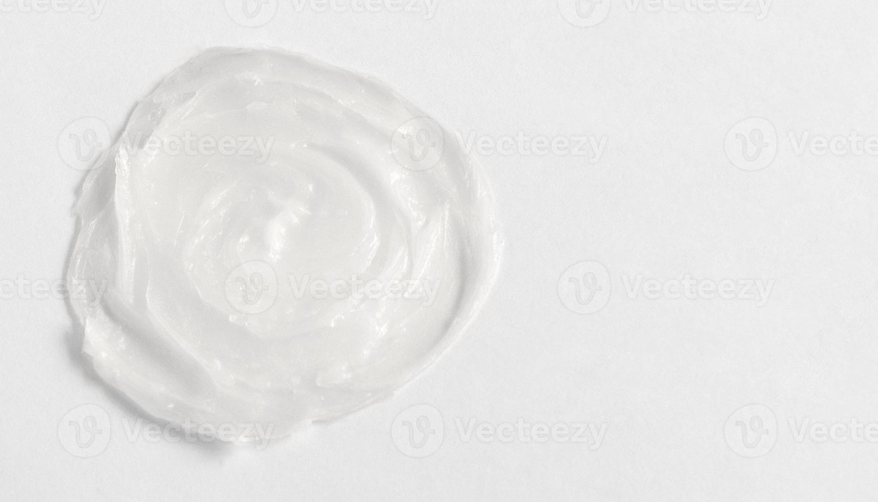 The texture of the lip balm. Transparent ointment on a white background and copy space photo