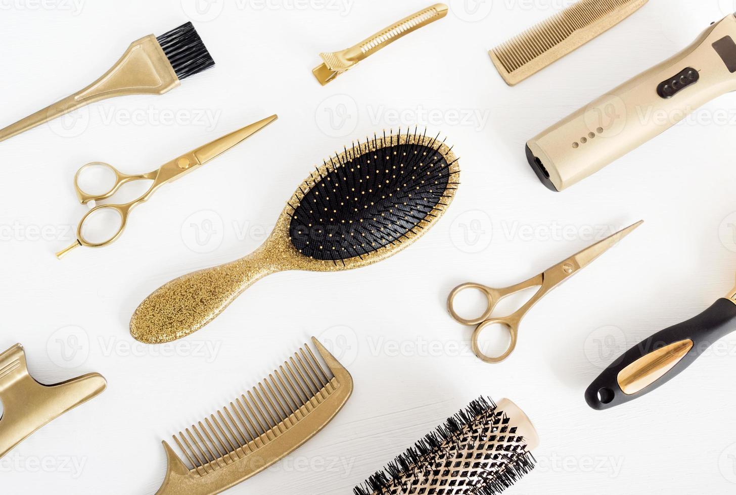 Background with golden hairdresser tools. Hair salon accessories, comb, scissors on white photo