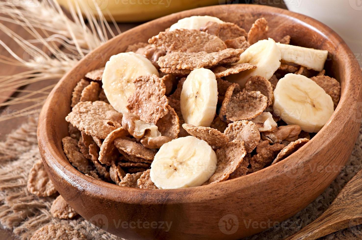 Healthy breakfast - whole grain muesli with a walnut in a wooden bowl photo
