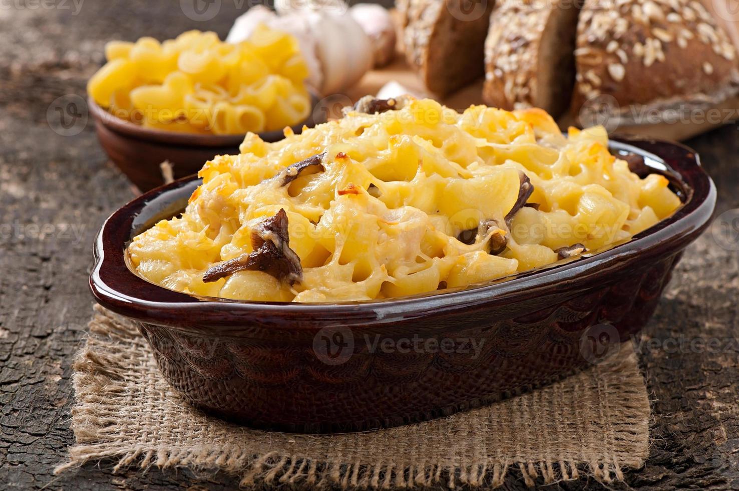 Macaroni with cheese, chicken and mushrooms baked in the oven photo