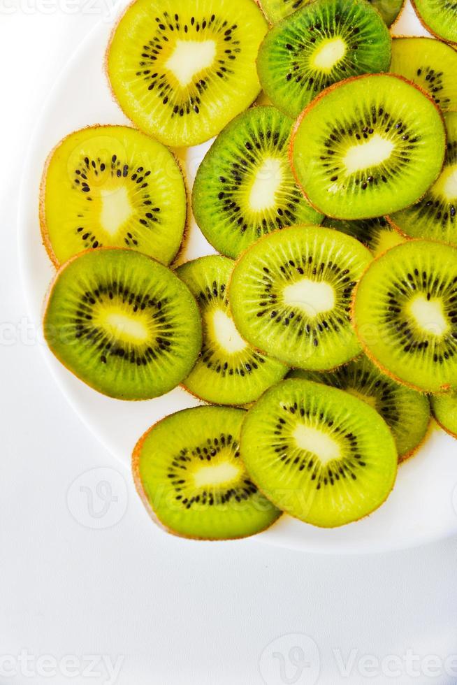 Kiwi fruit sliced on a white plate photo