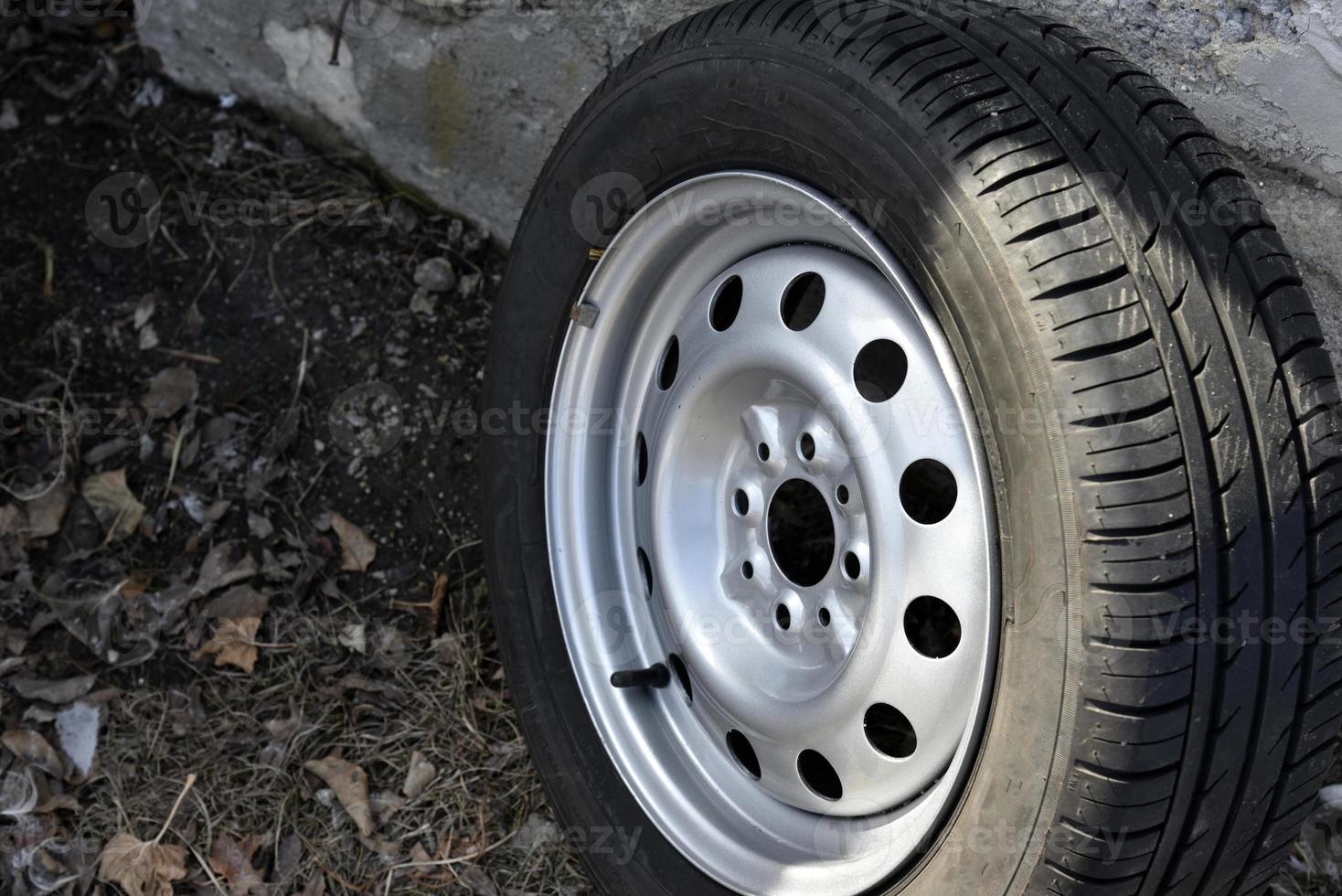 New tire with rubber on the iron disc of the car photo