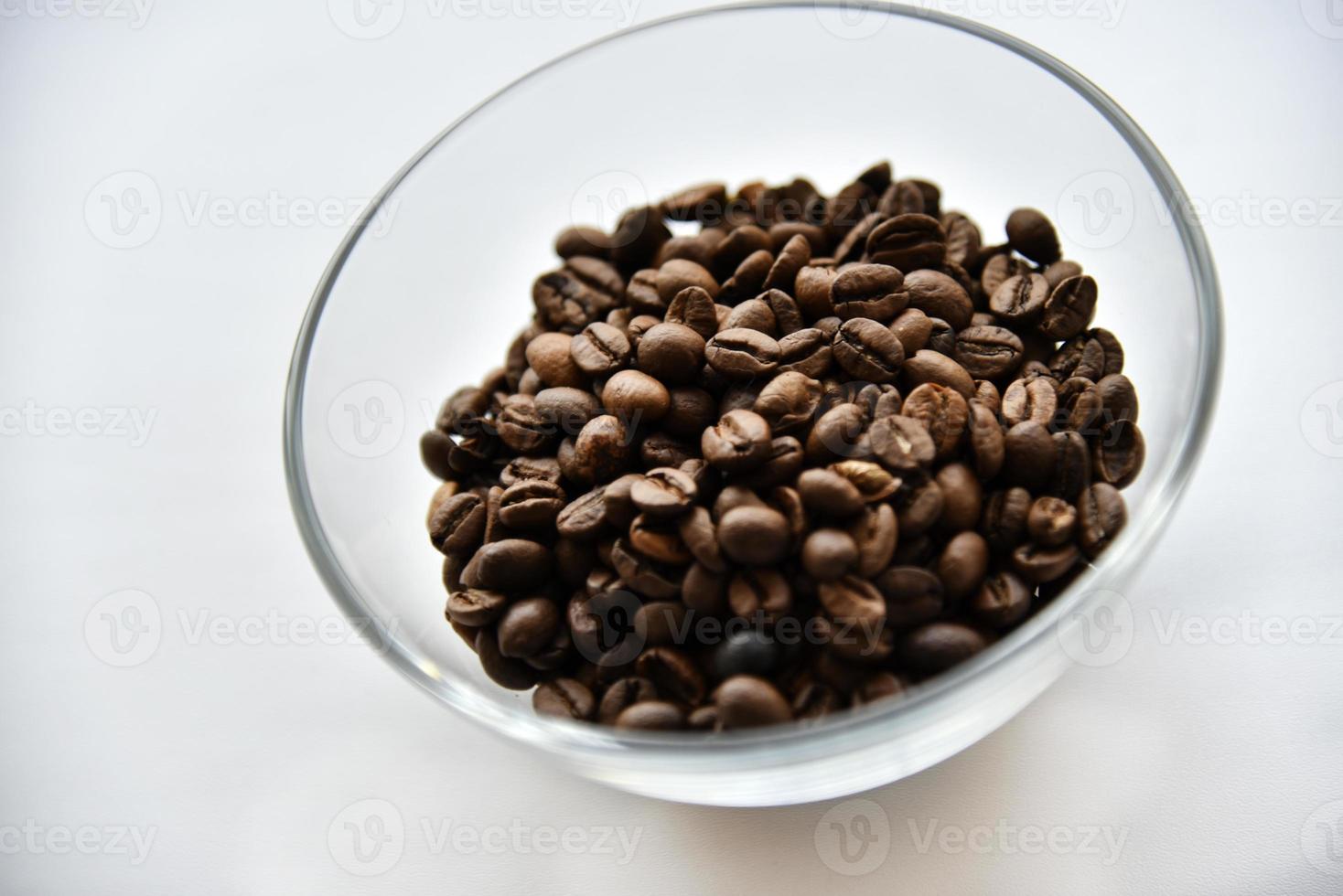 Coffee beans in a glass bowl on a white background photo