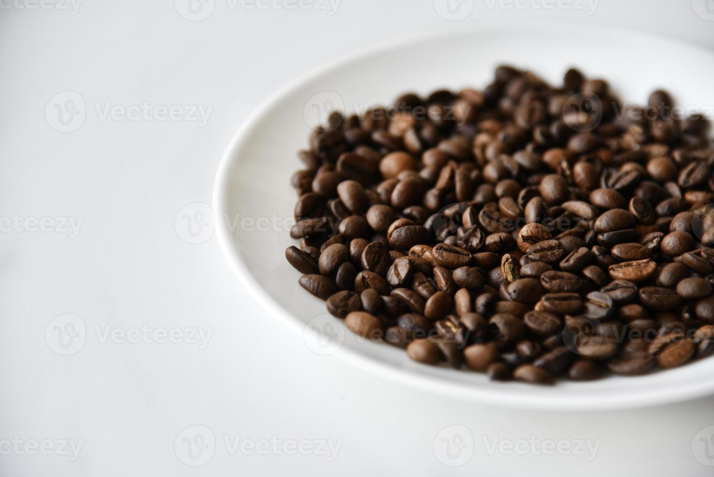 Roasted coffee beans on a white plate photo