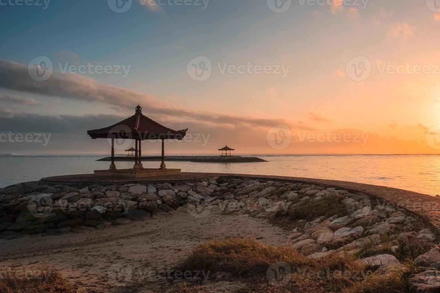 Bali pavilion on jetty at coastline in morning photo