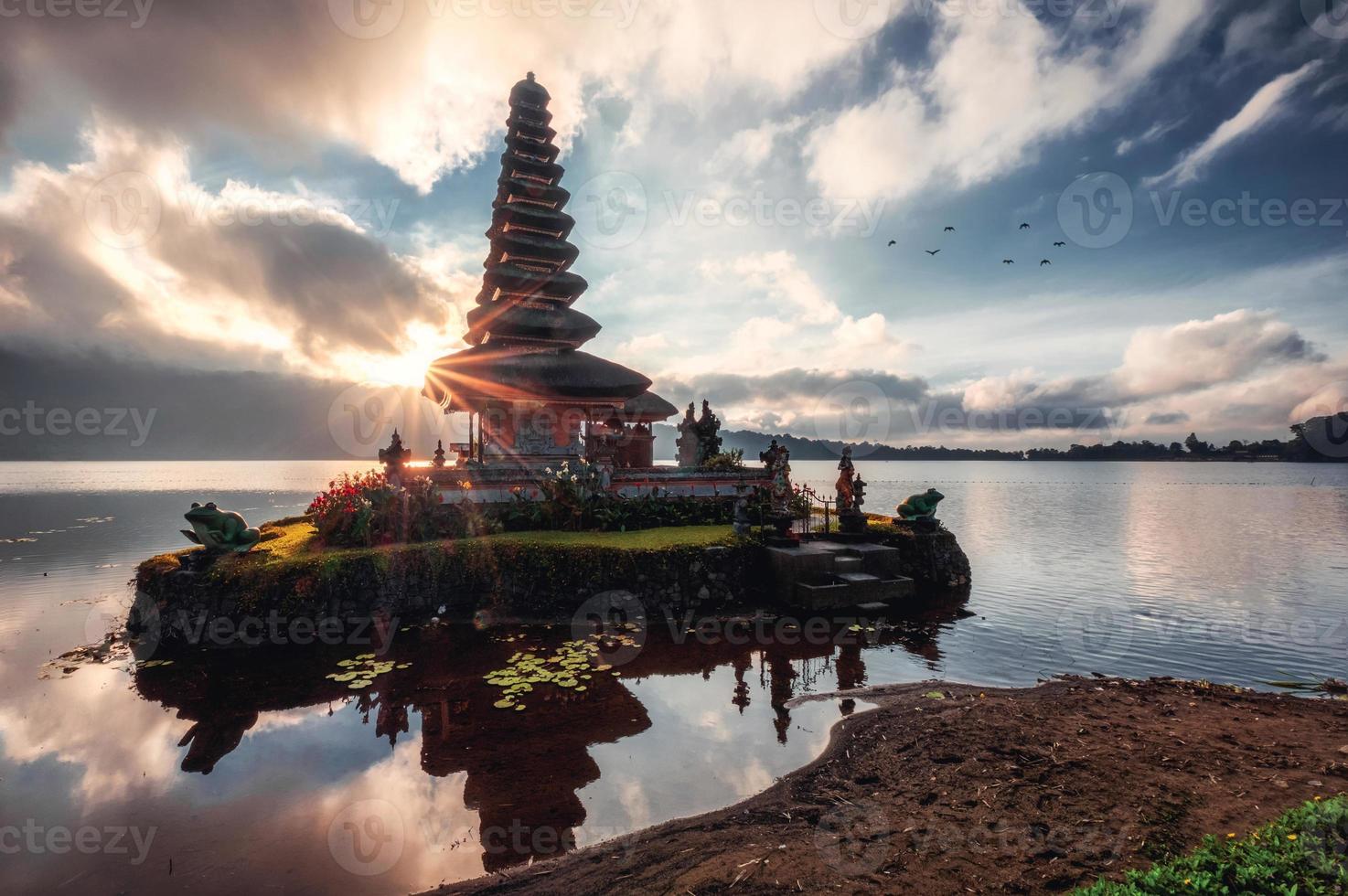 Sunrise shining on ancient temple of Pura Ulun Danu Bratan on Bratan Lake at Bali photo