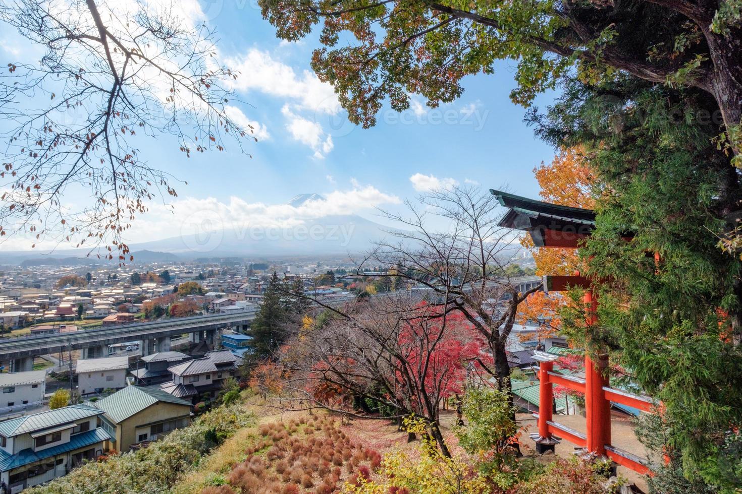 Red Torii gate in Arakura Sengen shrine with mount Fuji in autumn photo