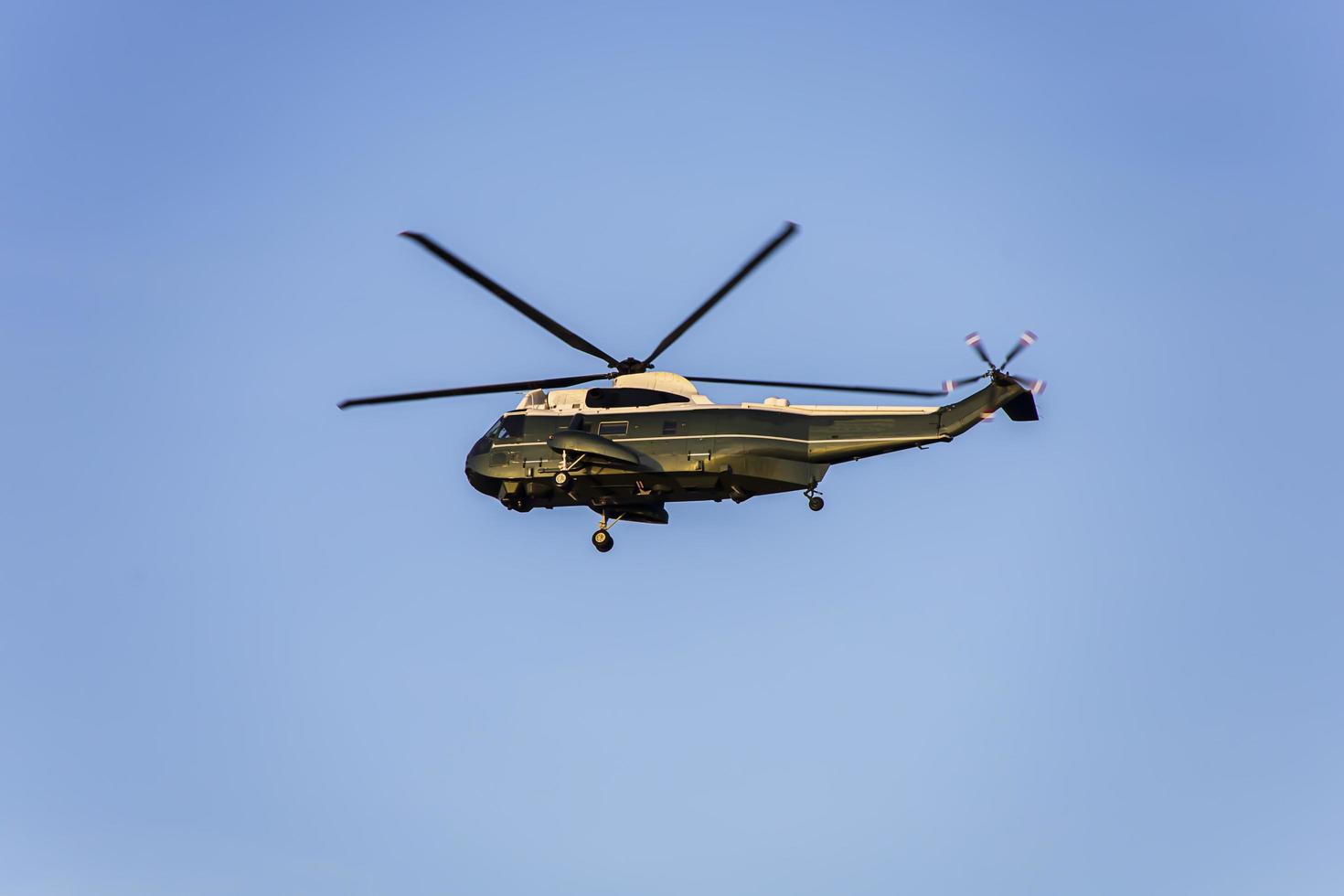 Green helicopter flying in the sky photo