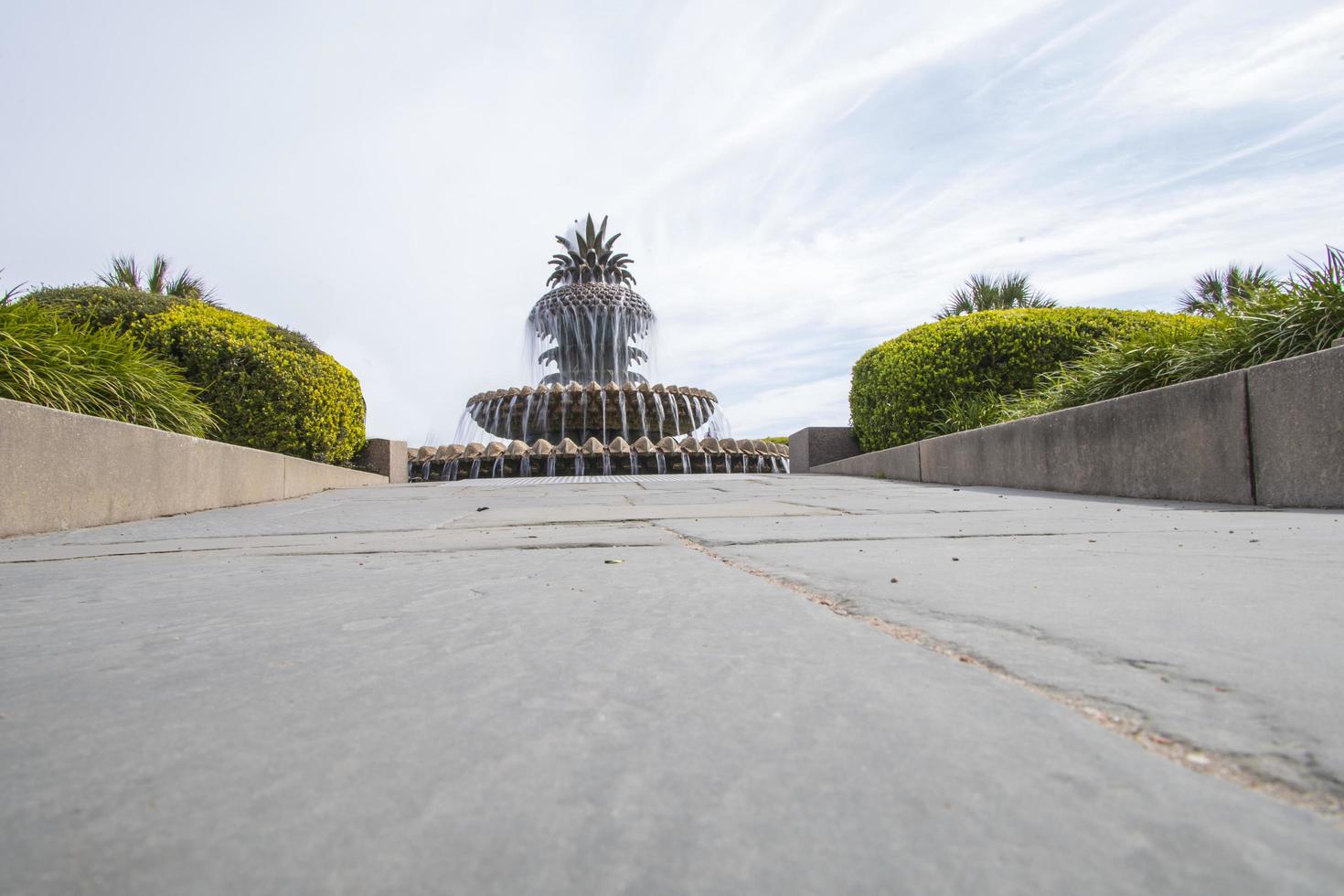 Pineapple fountain with flowing water in a park photo