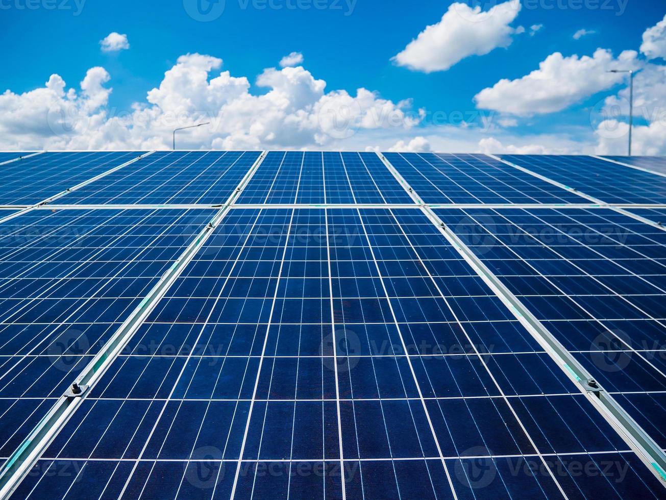 Solar panels with blue sky and clouds photo