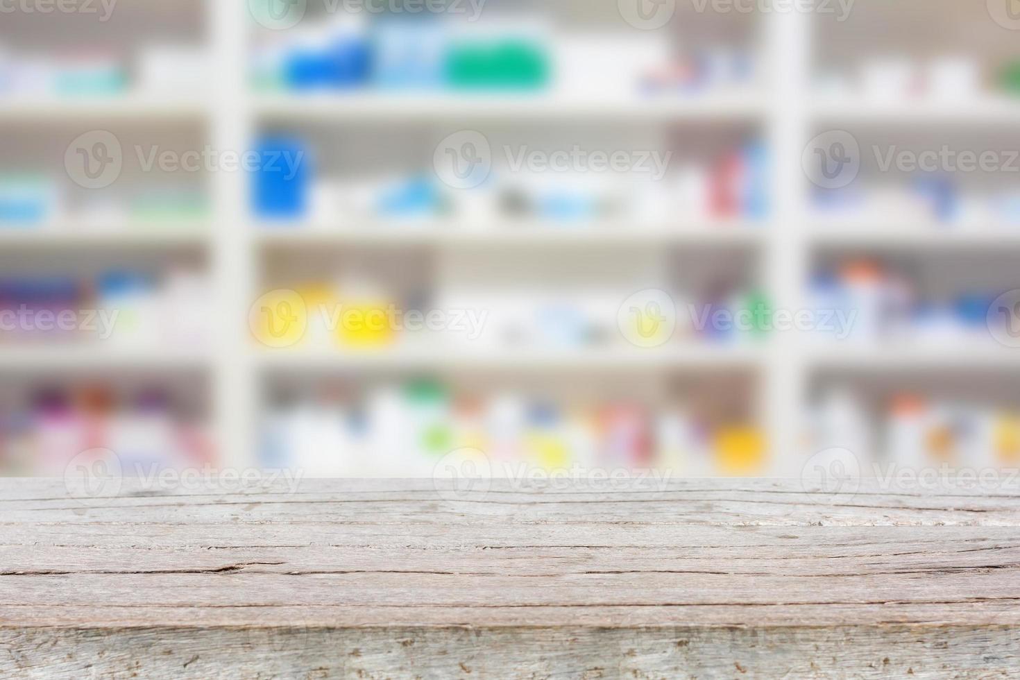 wood counter with blur shelves of drugs in the pharmacy photo