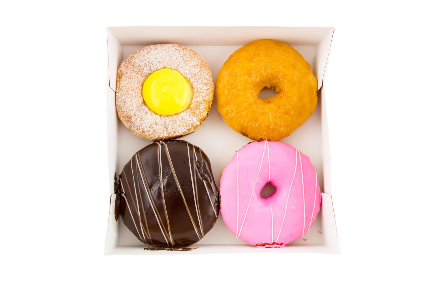 Cream chocolate and strewberry donut in the box, top view isolated on white photo