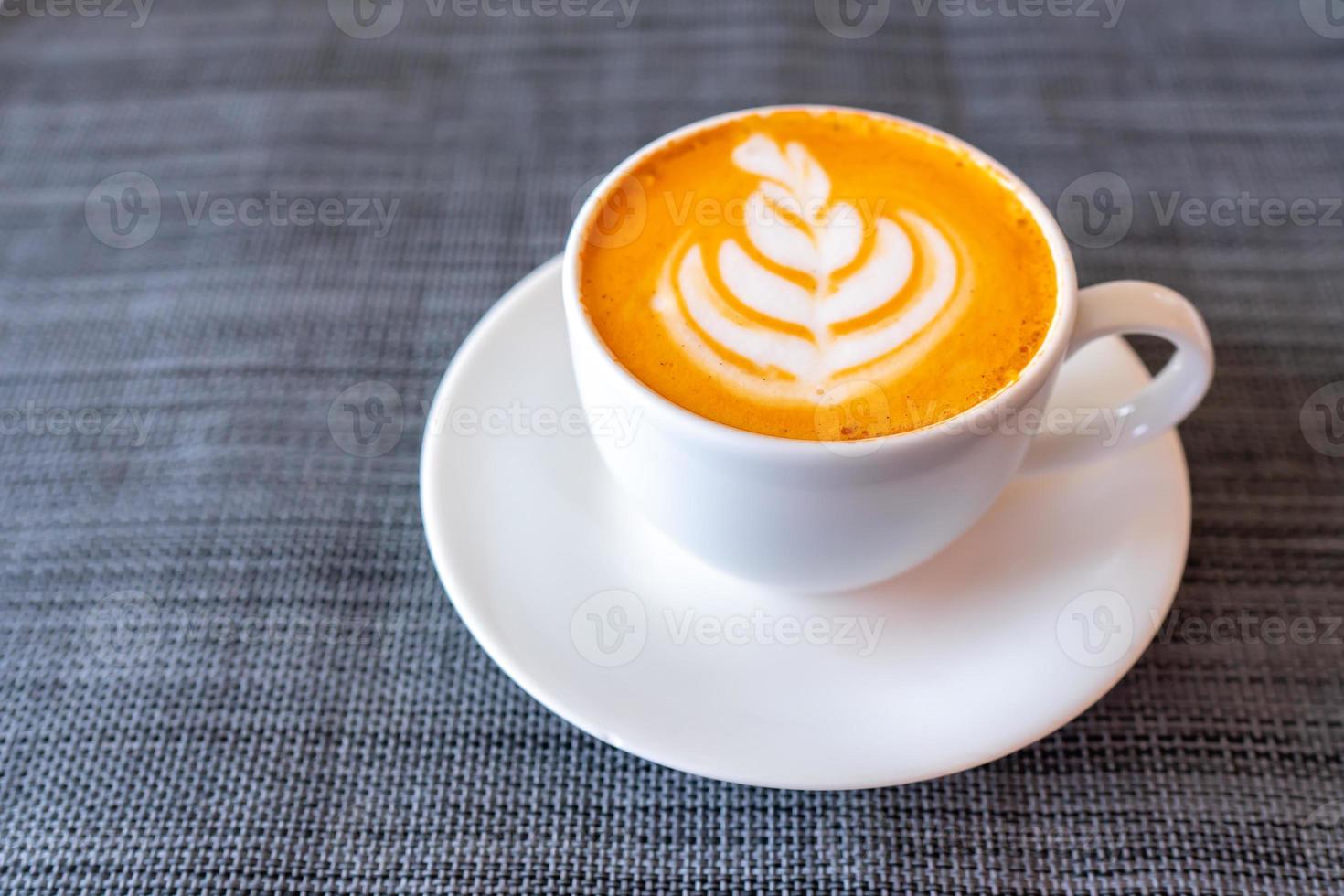 Hot tea with latte art in white coffee cup photo