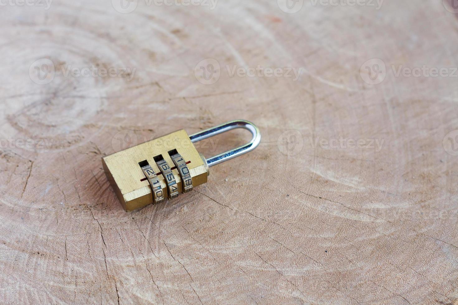 Close up pad lock on wooden background photo