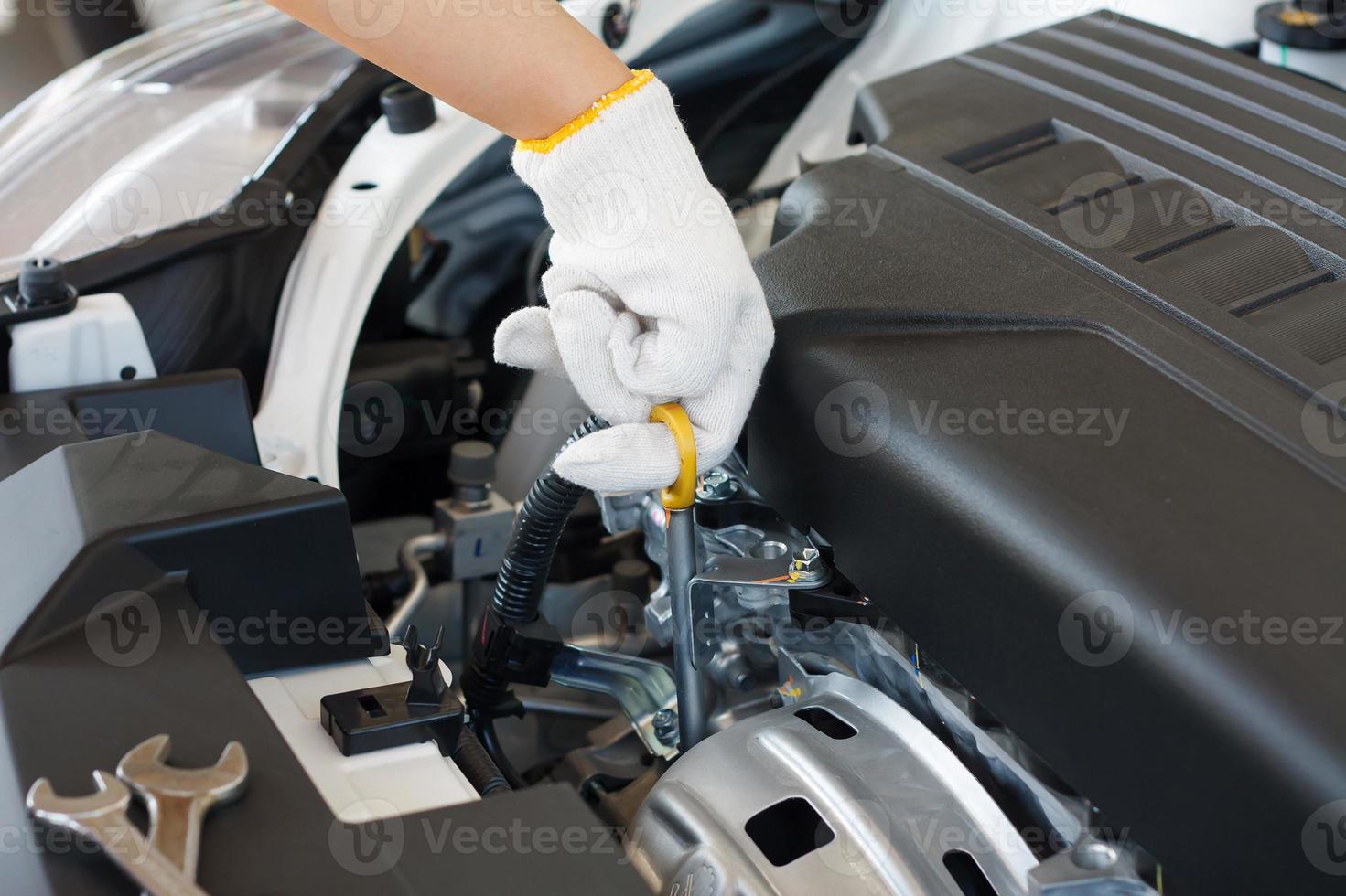 check the oil level in car engine photo
