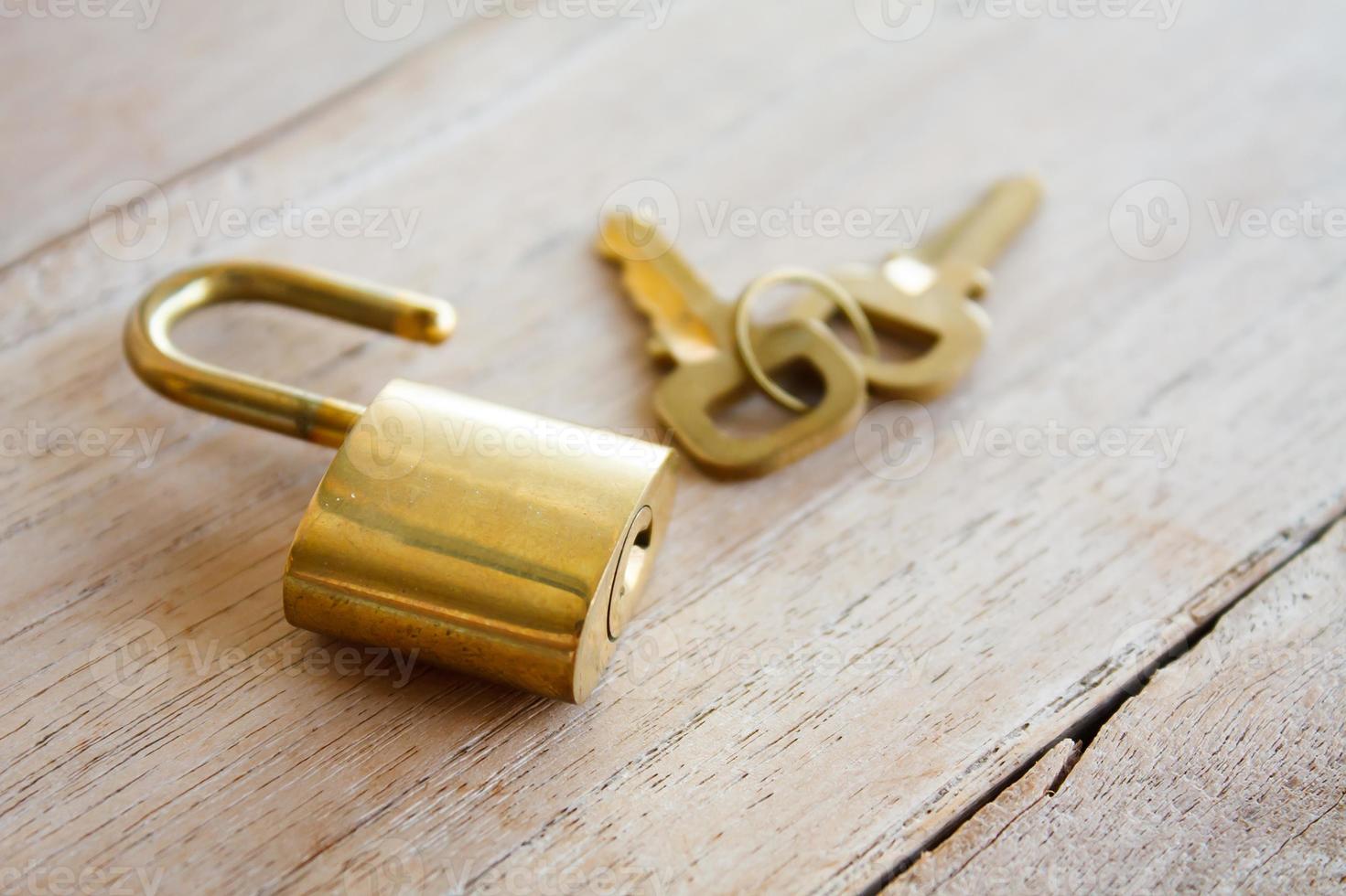 Golden padlock on wood background photo